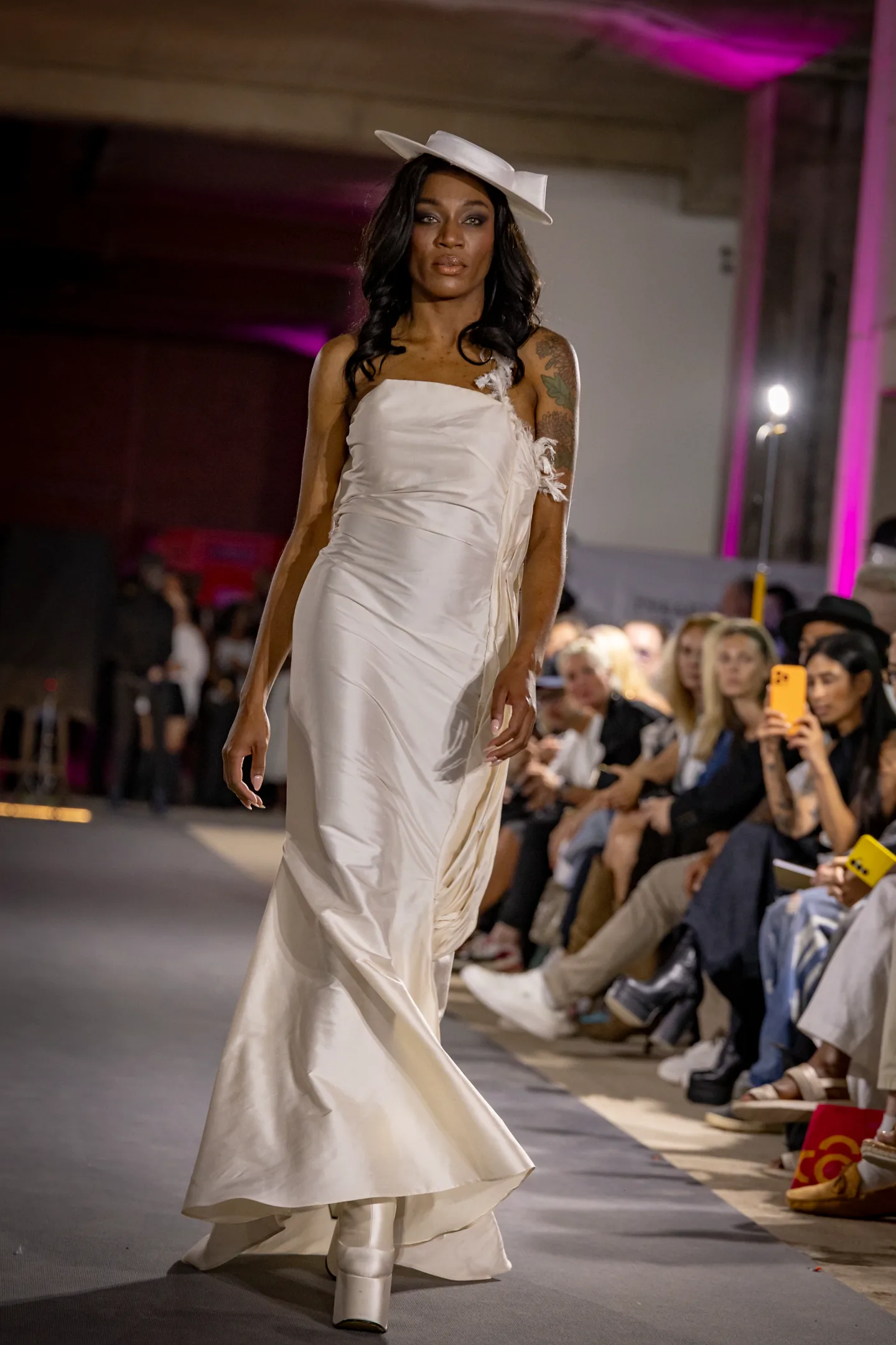 Portrait look with sculptural shoulders and strong pose.